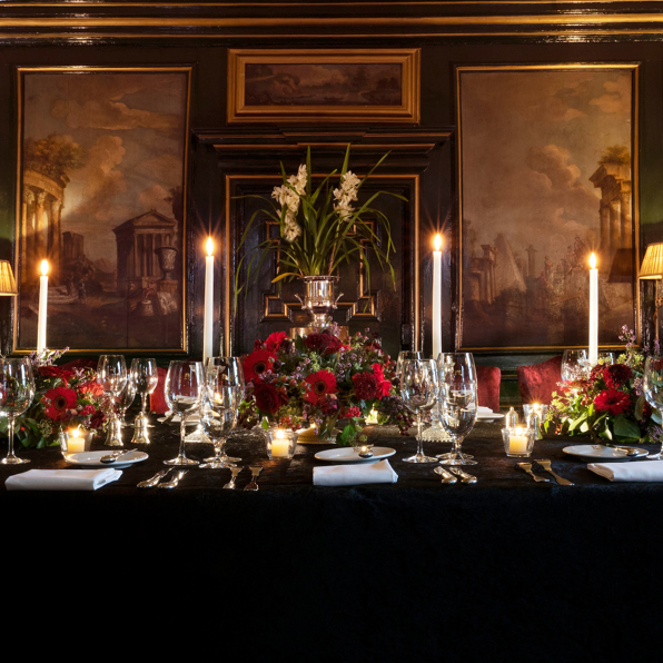 Table set with candles and paintings in the grand Italian private dining room at Prestonfield House Hotel Edinburgh 